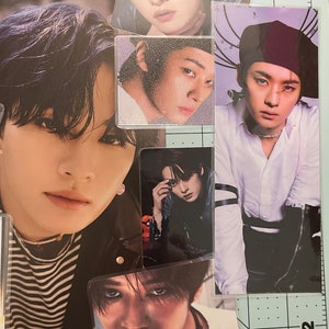 May include: A collection of photo cards featuring different portraits of men. The cards are printed on white paper with a glossy finish. The photos are in black and white and color.