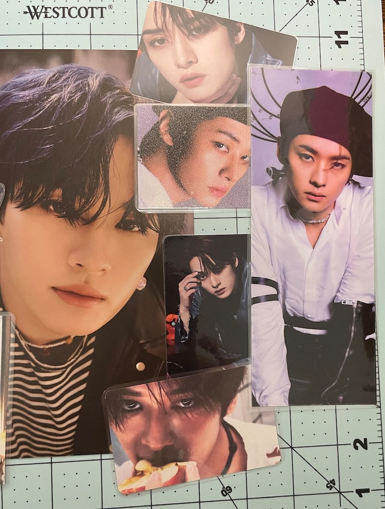 May include: A collection of photo cards featuring different portraits of men. The cards are printed on white paper with a glossy finish. The photos are in black and white and color.