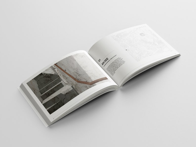 May include: An open book with a photo of a staircase with a wooden handrail on the left page and text on the right page that reads "01 AN ODE".