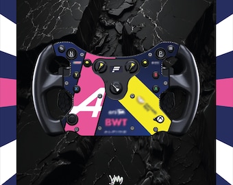 May include: A racing steering wheel controller featuring a black frame with pink, yellow, and dark blue panels. The centre includes buttons labelled N, P, Y, B, X, and A, along with a central dial, the BWT logo, and an Xbox symbol on the right side.