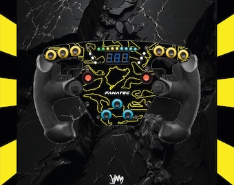 May include: Black and yellow racing wheel with the text "FANATEC". The wheel has multiple buttons and dials, with a digital display showing numbers. The design includes a yellow track outline.