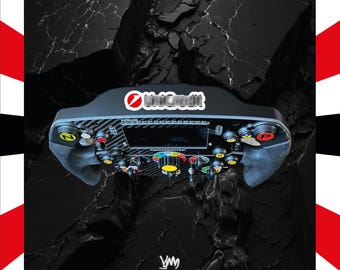 May include: A black carbon fibre racing steering wheel controller featuring a central digital display, multiple colourful push buttons, rotary dials, and the Thrustmaster logo. The device includes a UniCredit sticker and YM Custom branding.