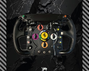 May include: A black carbon fibre racing steering wheel featuring numerous colourful rotary dials, push buttons, and toggle switches. The centre displays a yellow circular emblem, while the top and sides are finished in a textured black grip material.