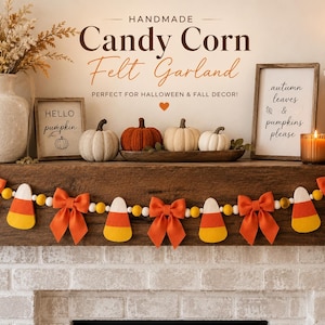 May include: A felt garland featuring alternating candy corn shapes and orange fabric bows strung on a cord with small yellow and white wooden beads. The candy corn pieces are colored with white, orange, and yellow horizontal stripes.