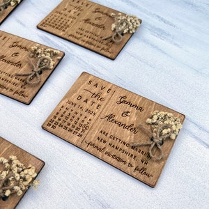 May include: Save the Date wedding announcement with a rustic wooden design. The announcement features a calendar with the date June 14, 2025, and the names Gemma & Alexander. The announcement also includes the text "Are getting married, New Hampshire, formal invitation to follow".