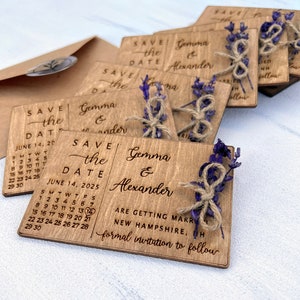 May include: Wooden save the date cards with a calendar design and the text "Save the Date" and "June 14, 2025". The cards also feature the names "Gemma & Alexander" and the text "Are getting married in New Hampshire, NH. Formal invitation to follow."