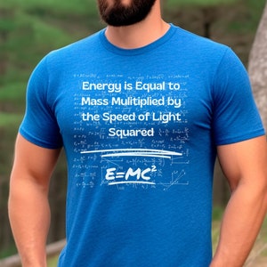 May include: A blue t-shirt with the equation "Energy is Equal to Mass Multiplied by the Speed of Light Squared" printed in white. The equation E=MC² is prominently displayed. The shirt is a crew neck style.