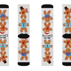 May include: A pair of white Christmas socks featuring a repeating pattern of gingerbread men in various outfits. The socks have black heels and toes, and the words "Merry Christmas" are printed on the side.