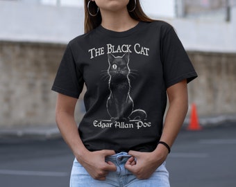May include: Black t-shirt with a white graphic of a black cat with one white eye. The text "The Black Cat" and "Edgar Allan Poe" are printed in white below the cat.