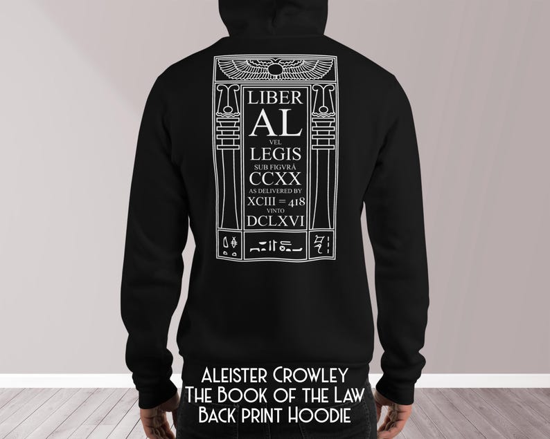 Puede incluir: Sudadera con capucha negra con un gr&aacute;fico blanco en la espalda. El gr&aacute;fico incluye el texto "LIBER AL VEL LEGIS" y otro texto en un marco rectangular. El texto "ALEISTER CROWLEY THE BOOK OF THE LAW BACK PRINT HOODIE" est&aacute; impreso en la parte inferior.