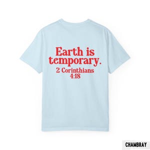 Pode incluir: Camiseta azul clara com o texto vermelho "Earth is temporary. 2 Corinthians 4:18". A camisa &eacute; feita de um material macio e tem um design cl&aacute;ssico de gola redonda. Uma pe&ccedil;a de roupa casual.
