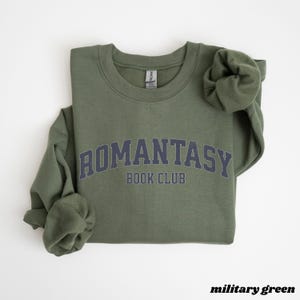 May include: A military green sweatshirt with the text "ROMANTASY BOOK CLUB" in a navy blue arch.