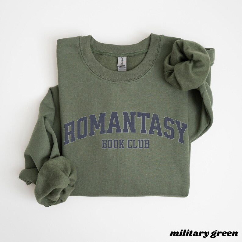 May include: A military green sweatshirt with the text "ROMANTASY BOOK CLUB" in a navy blue arch.
