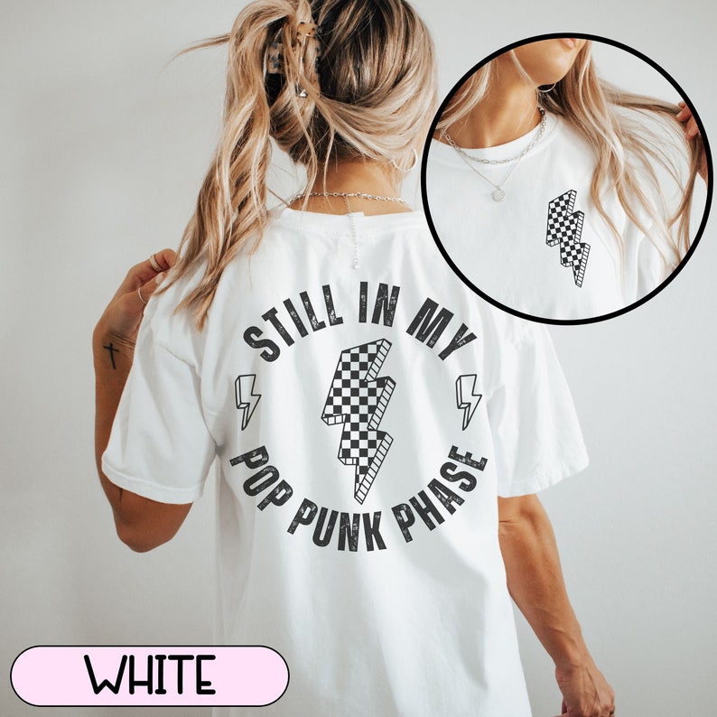 May include: White t-shirt with a black and white checkered lightning bolt graphic and the text "Still in my Pop Punk Phase".