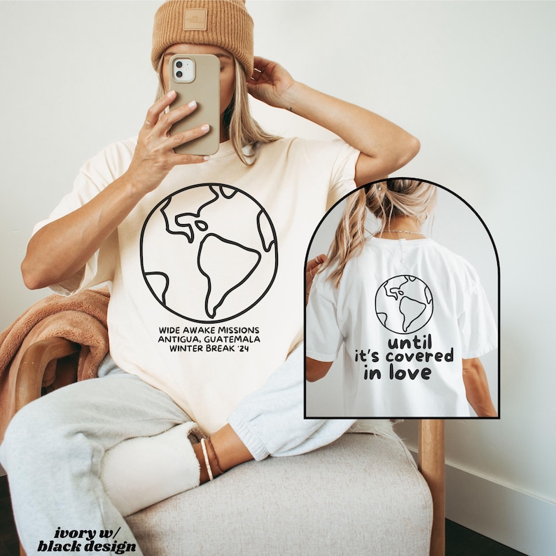 May include: Two ivory t-shirts with a black outline of the world on the front. The left shirt has the text "WIDE AWAKE MISSIONS ANTIGUA, GUATEMALA WINTER BREAK '24". The right shirt has the text "until it's covered in love".