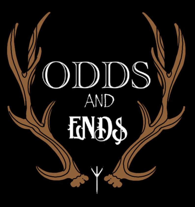 May include: A black and white graphic design with the text "ODDS AND ENDS" in a stylized font. The text is framed by two brown antlers.
