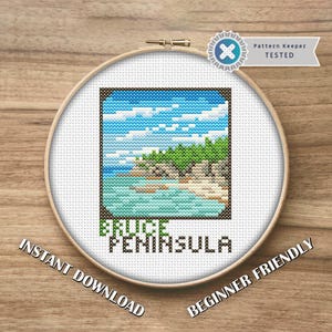 May include: A cross-stitch design of the Bruce Peninsula landscape, framed in a wooden hoop. The design features a blue sky, green trees, and turquoise water. Text includes "BRUCE PENINSULA", "INSTANT DOWNLOAD", and "BEGINNER FRIENDLY".
