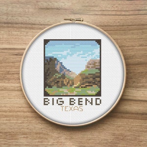 May include: A cross-stitch embroidery hoop with a colorful image of a canyon landscape. The text "BIG BEND TEXAS" is printed below the image.