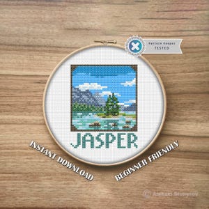 May include: A cross-stitch embroidery hoop with a landscape scene of mountains, water, and a tree under a blue sky. The word "JASPER" is stitched below the scene in teal. Text on the hoop reads "INSTANT DOWNLOAD" and "BEGINNER FRIENDLY".