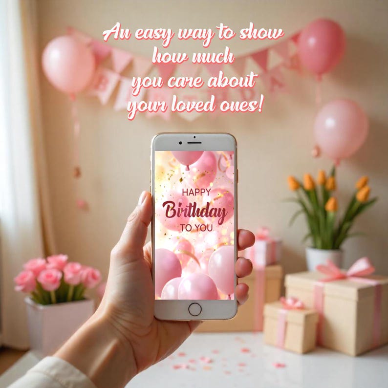 May include: A smartphone displaying a pink and gold birthday card with the text "Happy Birthday To You" surrounded by pink balloons. The phone is held in a hand against a background of pink balloons and gift boxes.