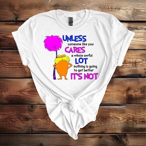 May include: White t-shirt with a cartoon character and the text "UNLESS someone like you CARES a whole awful LOT nothing is going to get better IT'S NOT".