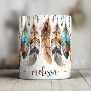 May include: White ceramic mug with a design of colorful feathers and gold accents. The name "melissa" is written in cursive at the bottom of the mug.