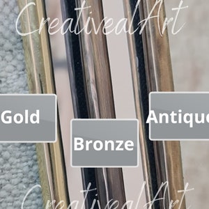 May include: Close-up of four metal strips in different finishes: gold, bronze, antique, and silver. The strips are labeled with their respective finishes. The image is captioned "CreativeArt".