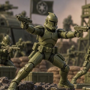 May include: An olive green action figure of a clone trooper in a dynamic combat pose, holding two blasters. The figure wears detailed armor with a helmet, utility belt, and leg plating, standing on a rocky surface with other figures in the background.