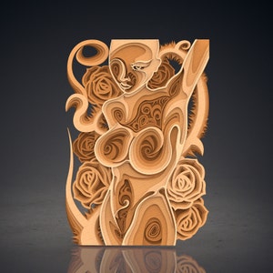 May include: A layered wooden art piece depicting a stylized female form with an arm raised. The artwork features intricate details and swirling patterns within the body, surrounded by rose motifs. The piece is crafted from various shades of wood.
