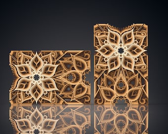 May include: Two decorative laser cut wooden panels with intricate floral designs in shades of brown and white. The panels are set against a black background and are reflected in a mirror-like surface.
