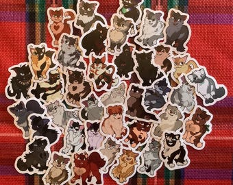 May include: A collection of 40 colourful cartoon cat stickers. The stickers feature various cat breeds and poses, including a black cat, a tabby cat, a calico cat, and a white cat. The stickers are perfect for adding a touch of whimsy to laptops, water bottles, journals, and more.