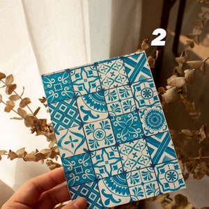 May include: A close-up of a card with a blue and white patterned design. The pattern is reminiscent of traditional Portuguese tiles.