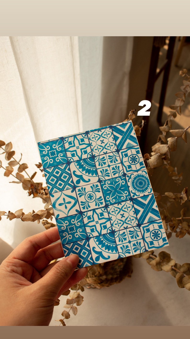 May include: A close-up of a card with a blue and white patterned design. The pattern is reminiscent of traditional Portuguese tiles.