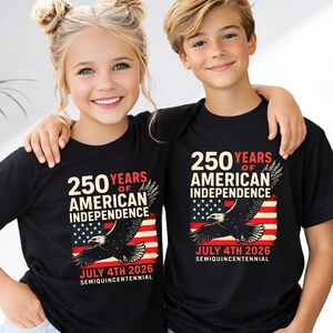 Youth boy and girl wearing matching 250 Years of American Independence patriotic shirts smiling together