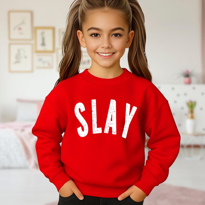 Red youth sweatshirt with bold distressed SLAY design in white, trendy girls graphic sweater, kids fashion outfit mockup, teen girl aesthetic clothing, cozy unisex fleece crewneck.