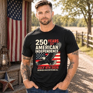 Adult man wearing black America 250 patriotic tshirt with eagle and American flag graphic celebrating 250 years of American independence July 4th 2026 patriotic apparel for men.