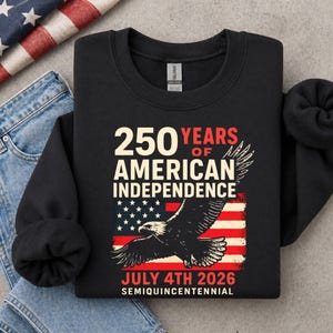 Folded black America 250 sweatshirt with bald eagle patriotic design and distressed American flag graphic celebrating 250 years of American independence for July 4th 2026.