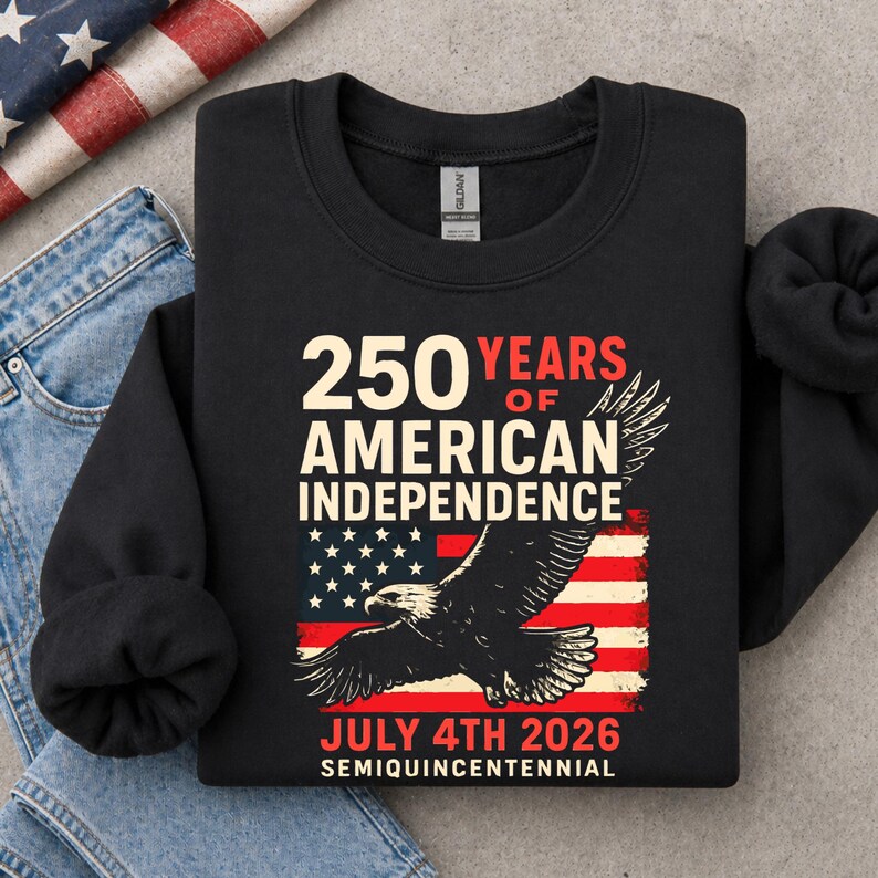 Folded black America 250 sweatshirt with bald eagle patriotic design and distressed American flag graphic celebrating 250 years of American independence for July 4th 2026.