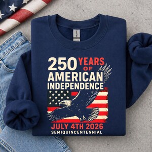 Folded navy blue America 250 sweatshirt with patriotic eagle and distressed USA flag design for July 4th 2026 semiquincentennial celebration patriotic crewneck apparel.