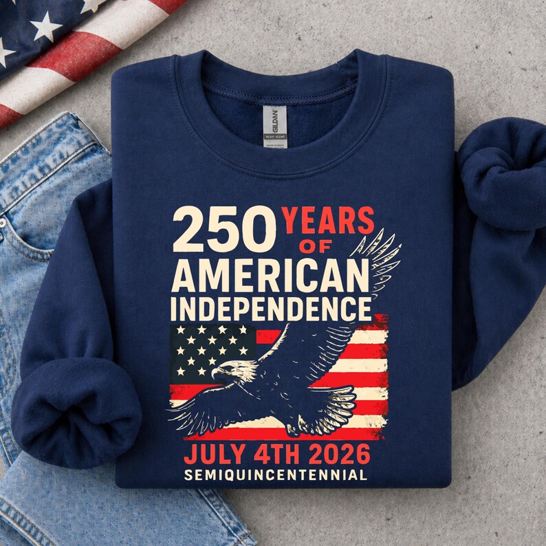 Folded navy blue America 250 sweatshirt with patriotic eagle and distressed USA flag design for July 4th 2026 semiquincentennial celebration patriotic crewneck apparel.