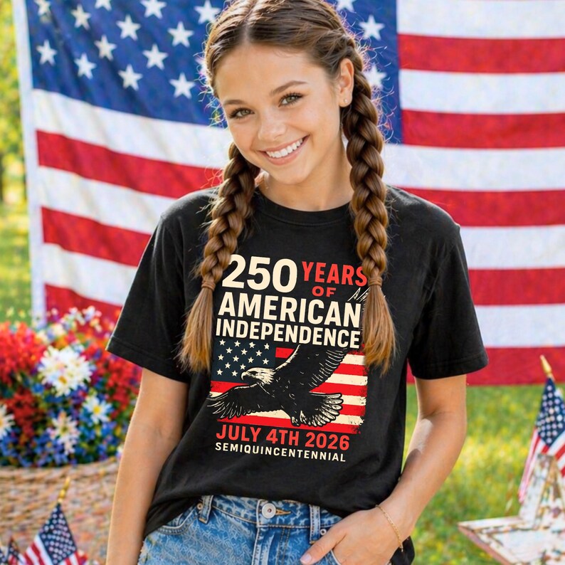 Youth girl wearing black America 250 shirt with patriotic eagle and American flag graphic celebrating July 4th 2026 semiquincentennial patriotic tshirt for girls kids and youth summer holiday outfit.