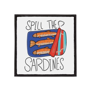 May include: A white patch with black trim features a cartoon illustration of a can of sardines with the text "Spill the Sardines" above the can.