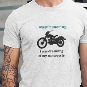 May include: White t-shirt with a black and white illustration of a motorcycle and the text "I wasn't snoring I was dreaming of my motorcycle".