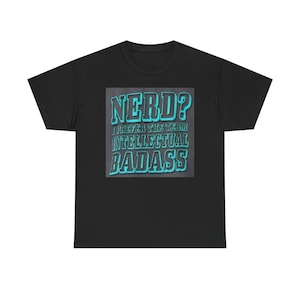 May include: Black t-shirt with a rectangular graphic. The graphic features the word "NERD?" in a bold, teal font, followed by "I PREFER THE TERM INTELLECTUAL BADASS" in a similar style. The shirt is a casual wear item.