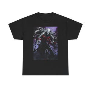 May include: Black t-shirt featuring a graphic of a long-haired, pale-skinned figure in dark clothing with red accents. The artwork has a fantasy theme, with a dark, atmospheric background.