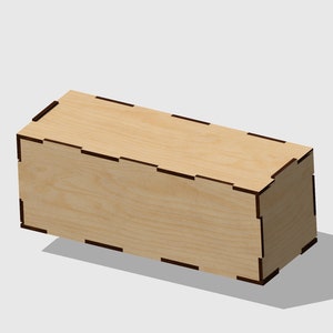 May include: A rectangular wooden box with a light wood grain finish. The box has dark brown accents at the corners and along the edges, creating a contrast. The box is angled slightly, casting a shadow.