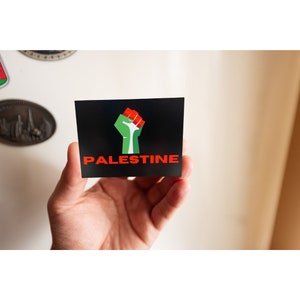Free Palestine Magnet Holding Flag Palestine Power Hand for Palestine Flag all profits donated to The Palestinian Children’s Relief Fund