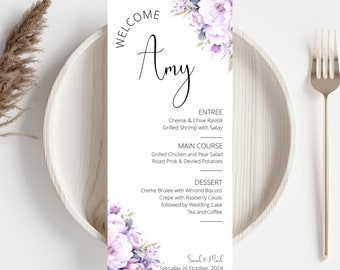 May include: A wedding menu card with a purple floral design. The card features the name "Amy" at the top and lists the menu items for the wedding reception. The menu includes cheese and chive ravioli, grilled shrimp with satay, grilled chicken and pear salad, roast pork and deviled potatoes, creme brulee with almond biscotti, crepe with raspberry coulis, wedding cake, tea and coffee. The card also includes the names "Sarah & Mark" and the date "Saturday 26 October, 2024".