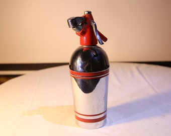 May include: A vintage silver and red soda siphon with a lever on the top.