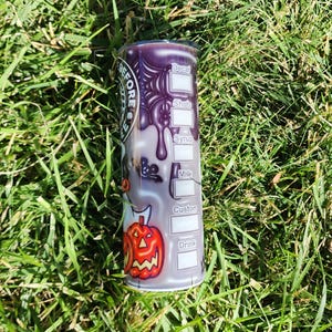 May include: A purple and black stainless steel tumbler with a Halloween-themed design. The tumbler has a white label with the words "Decaf", "Shots", "Syrup", "Milk", "Custom", and "Drink" printed on it.